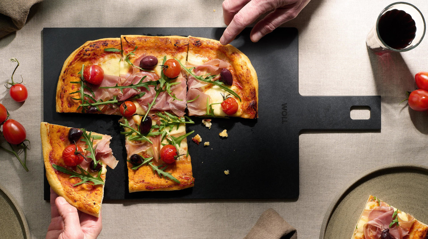 Pizza served on a Woll Cut & Serve cutting board, demonstrating use as a serving platter