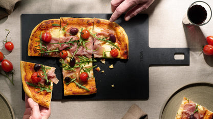 Pizza served on a Woll Cut & Serve cutting board, demonstrating use as a serving platter