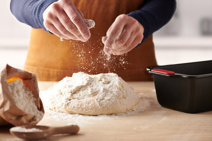 Woll Let's Bake! loaf pan with bread dough rising, showing leak-proof seamless base