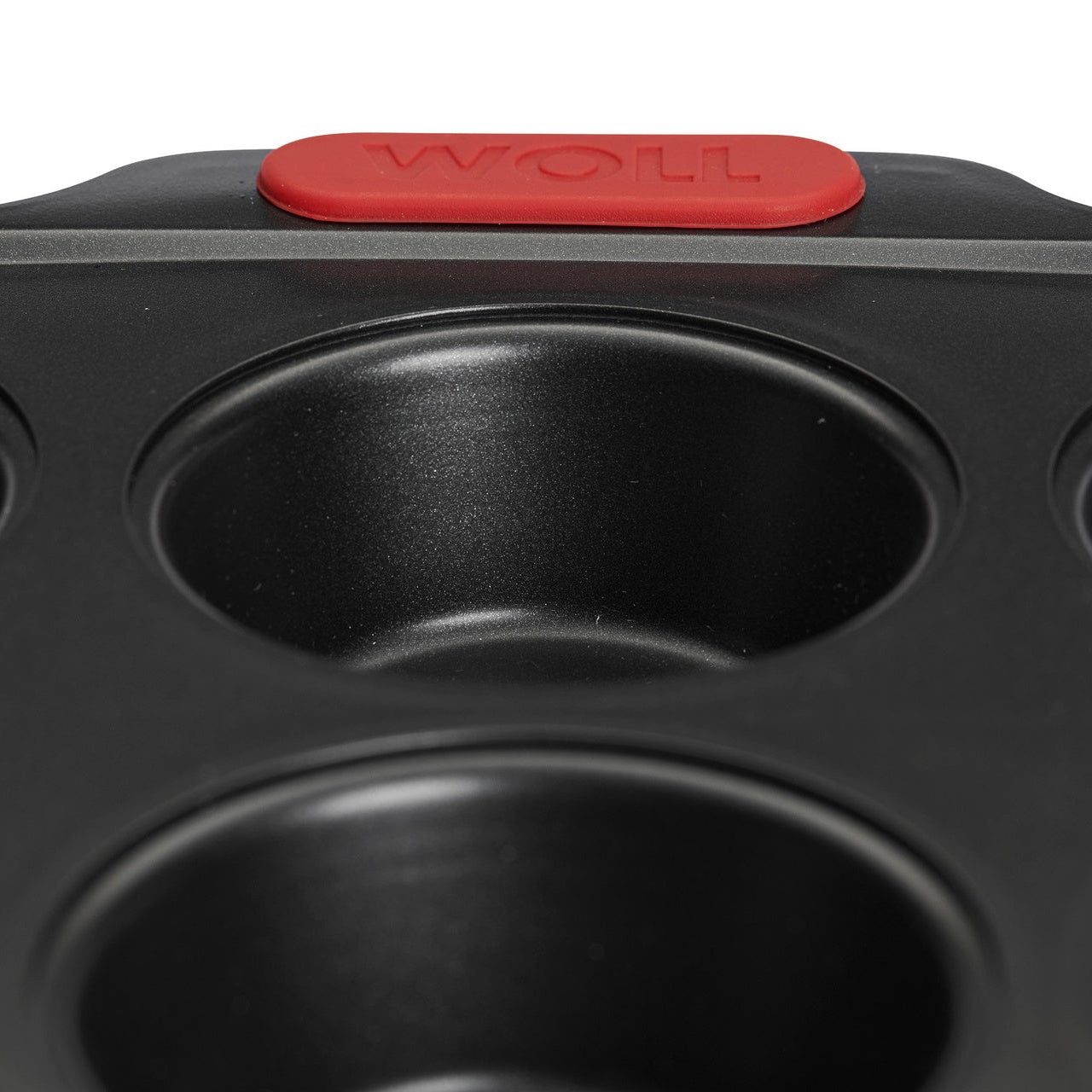 Close-up detail of Woll muffin pan non-stick coating and silicone grip