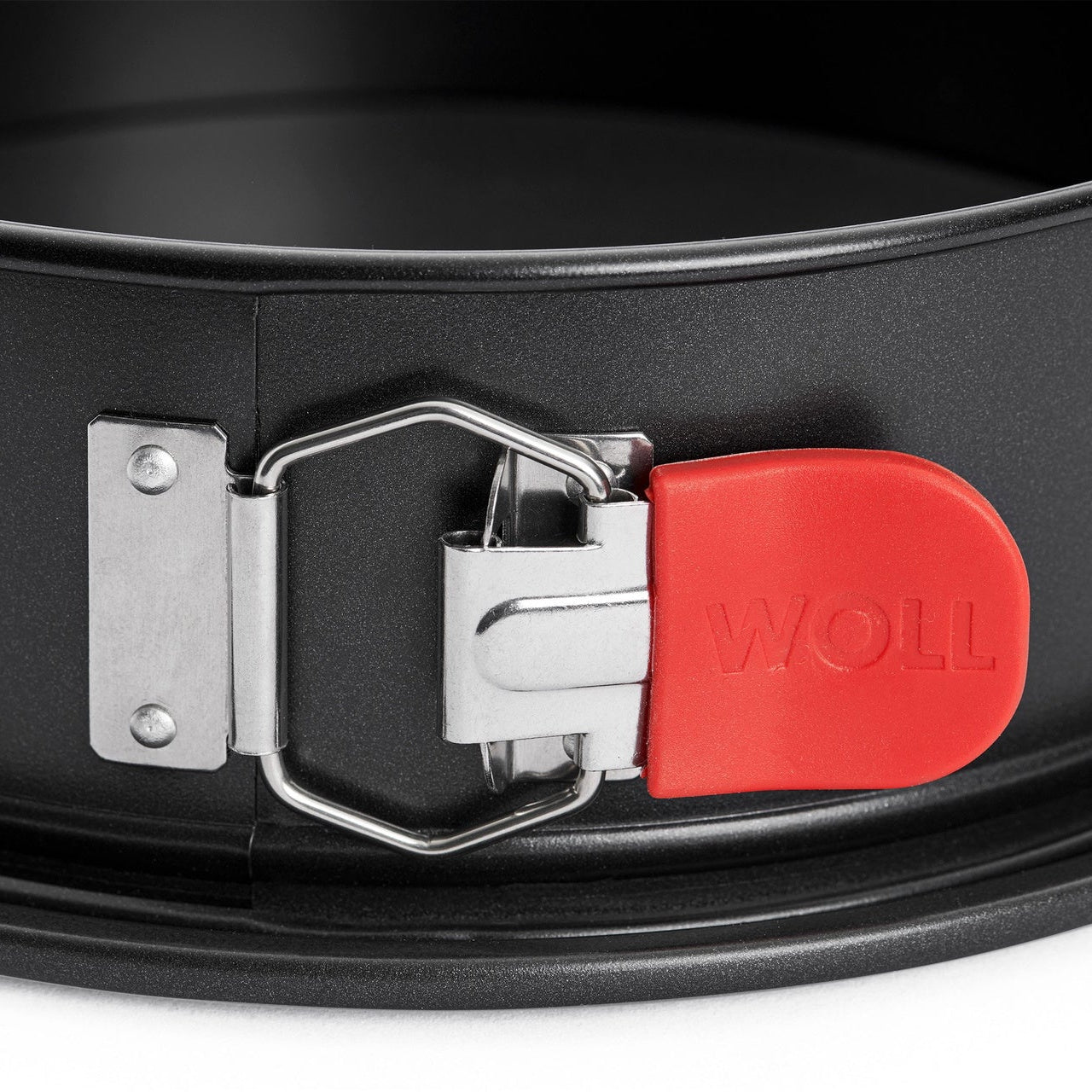 Close-up detail of Woll springform pan's quick-release clasp and leak-proof seal